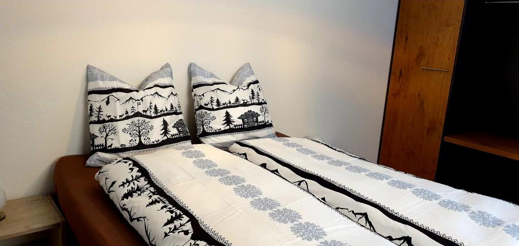 a bed with two pillows on top of it at Loft4two in Meiringen