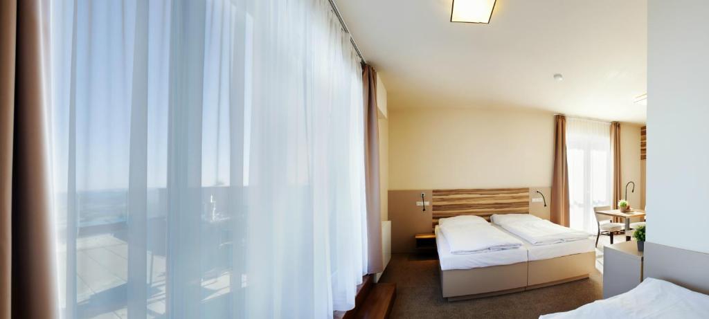 Postel nebo postele na pokoji v ubytování Hotel Monínec