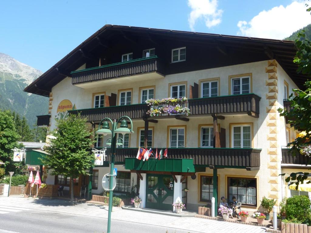 a large building on the side of a street at ALPINA Appartements Mallnitz in Mallnitz