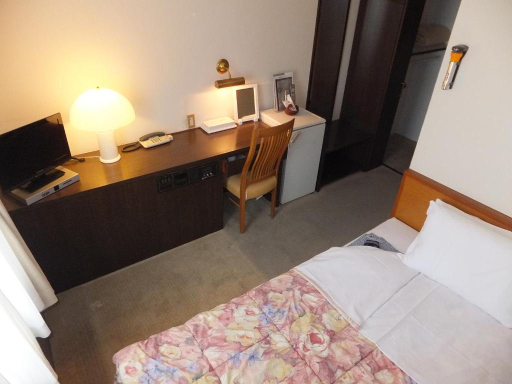 Postel nebo postele na pokoji v ubytování Suzuka Royal Hotel
