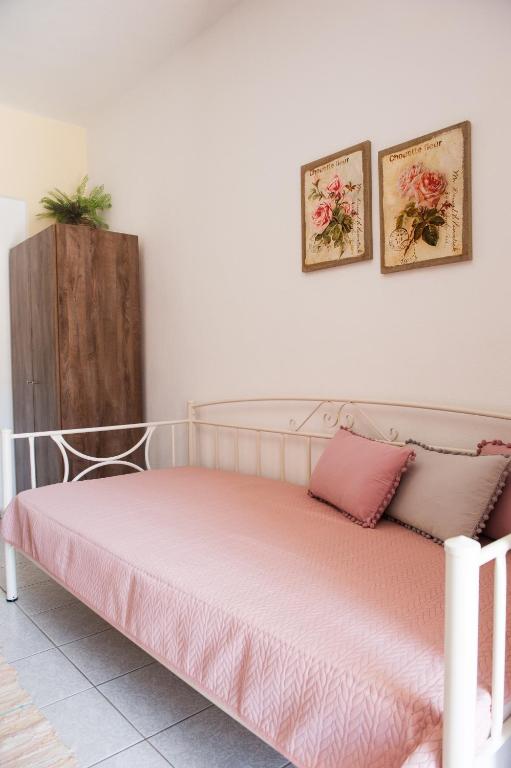 a bedroom with a bed with a pink mattress at Maria Village in Vourvourou