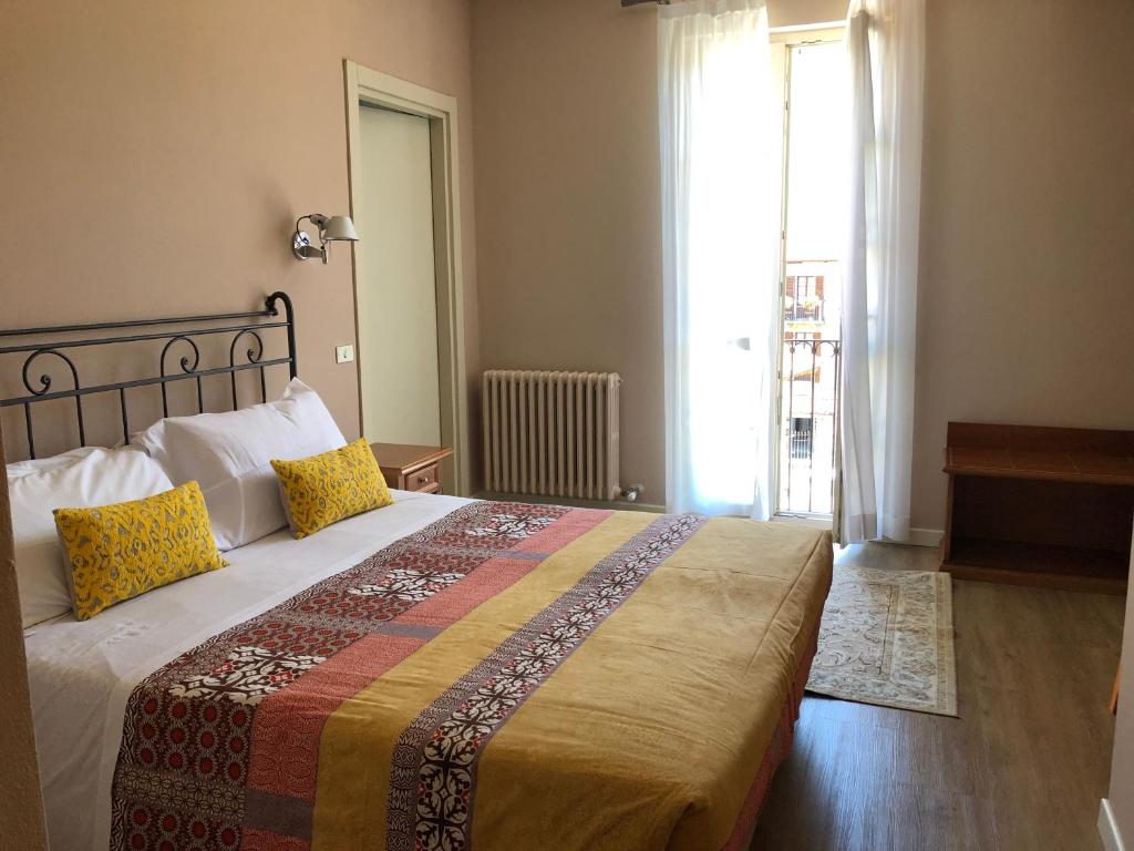 Postel nebo postele na pokoji v ubytování Hotel Antica Stallera
