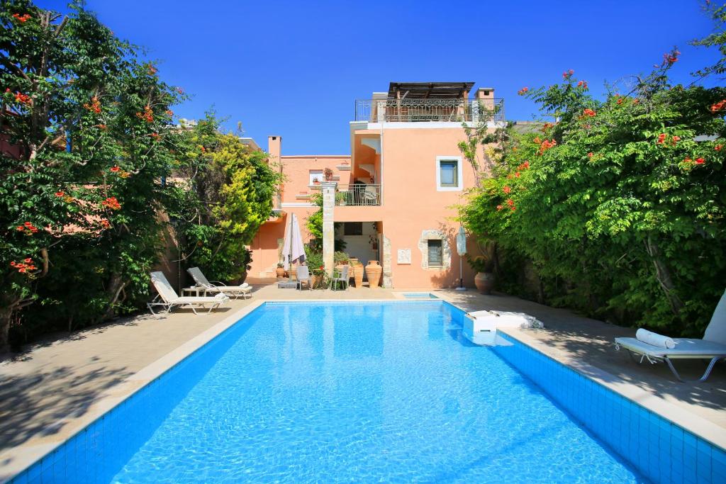 a swimming pool in front of a house at Villa Pasiphae in Kamilari