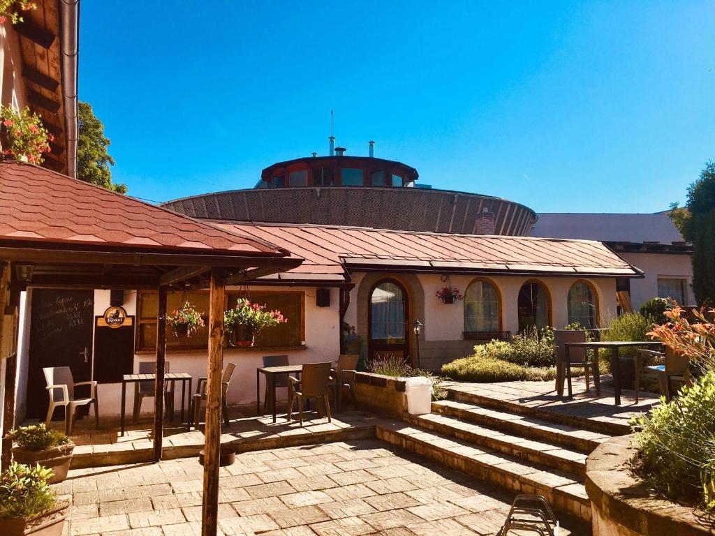 a house with a patio with a table and chairs at Pension Verona in Nový Bor