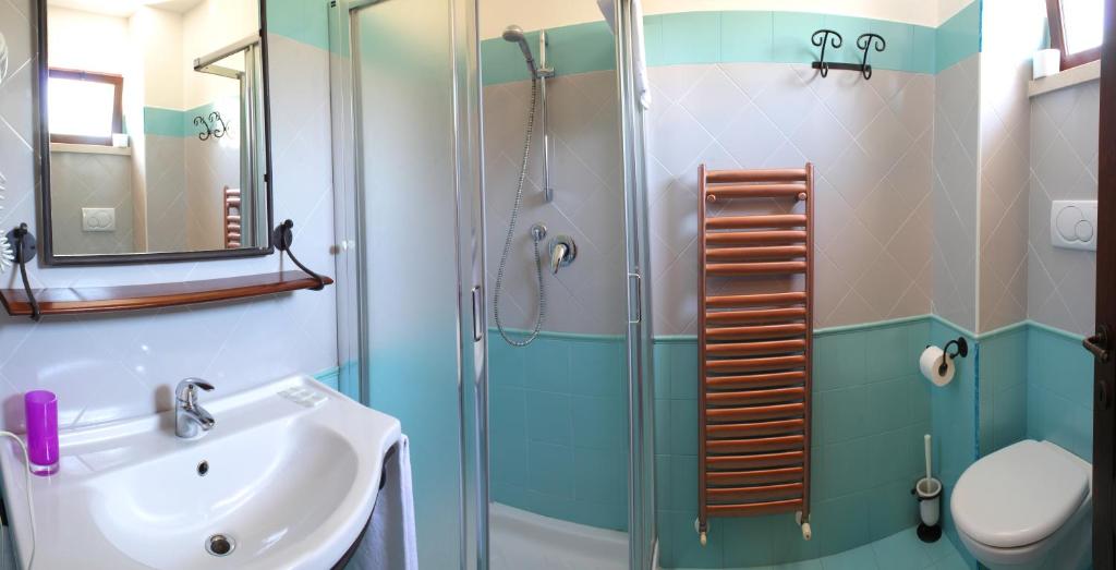 a bathroom with a glass shower and a sink at Country House La Foggetta in Pineto