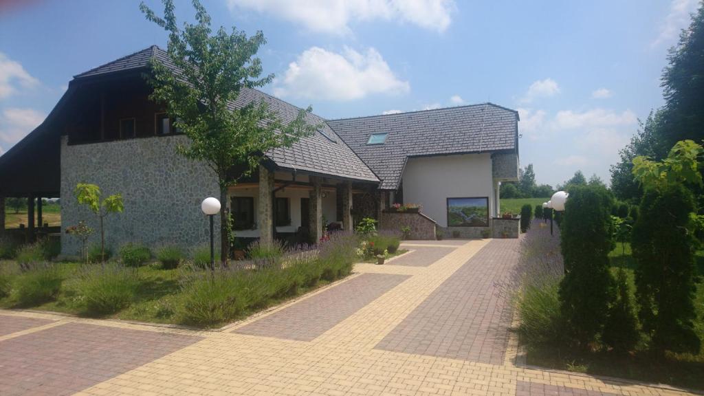 a house with a brick walkway in front of it at Villa Stone in Rakovica