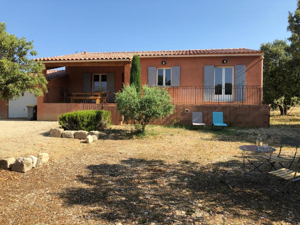 a house with a large yard in front of it at La Maison Bougnette in Flassan