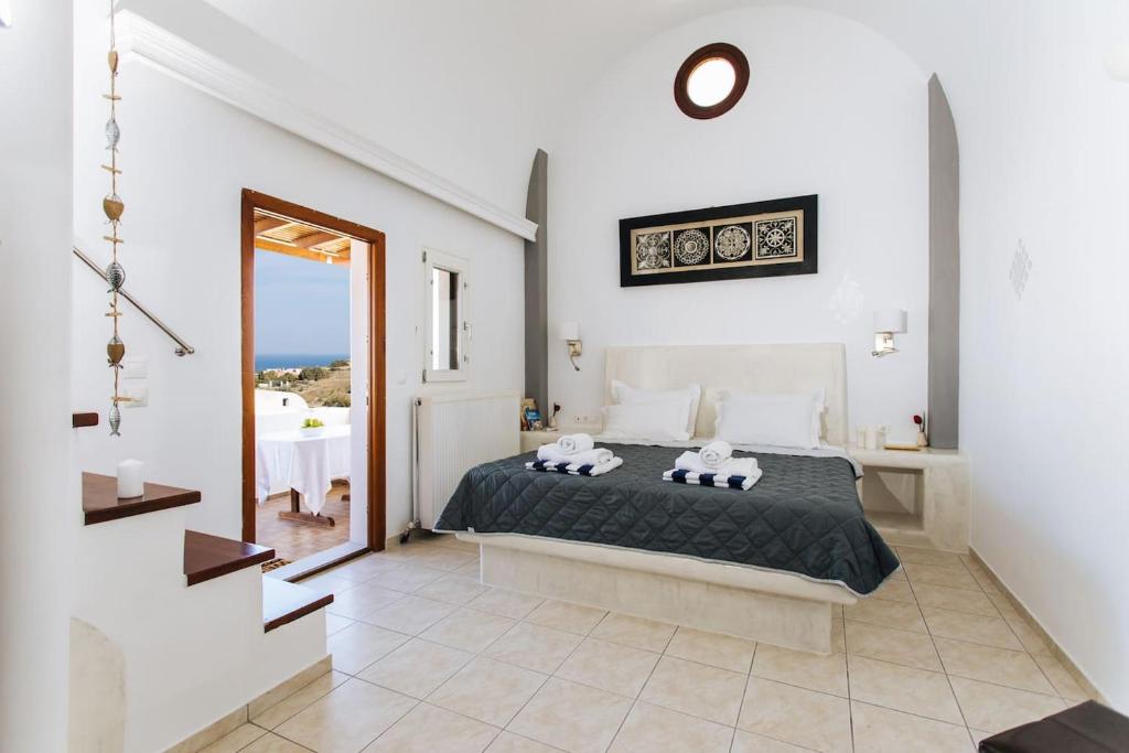 a bedroom with a bed and a view of the ocean at Sun Stories Suites in Vóthon