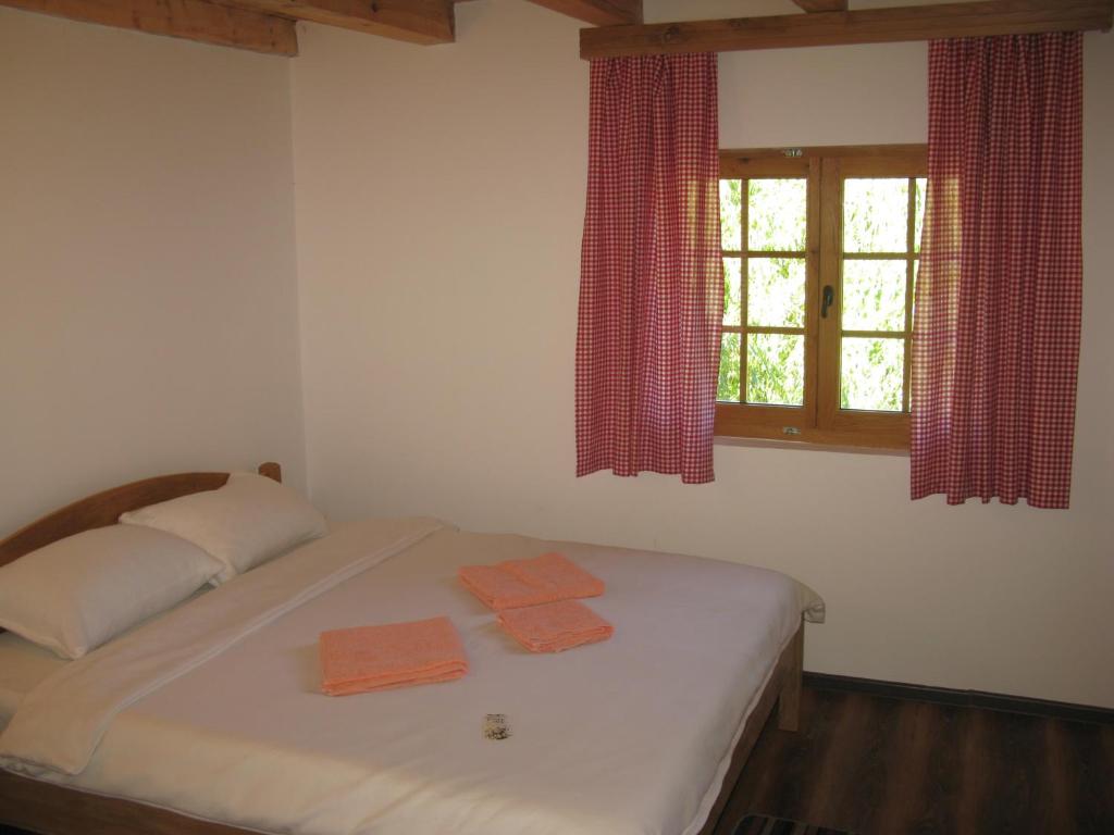 a bedroom with a bed with two towels on it at Vodenica Lug in Strmosten
