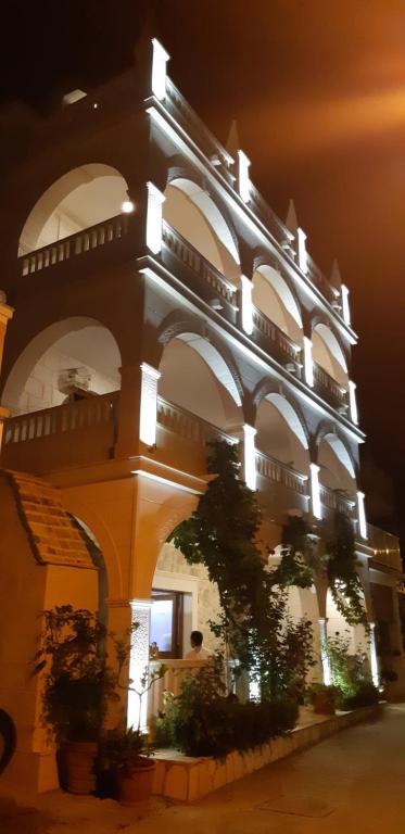 a large building with lights on it at night at Villa Stonehouse in Milna