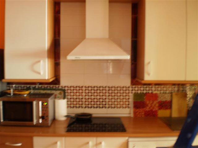 a kitchen with white cabinets and a counter top at Apartamentos Atlanterra COSTA Y SOL in Zahara de los Atunes
