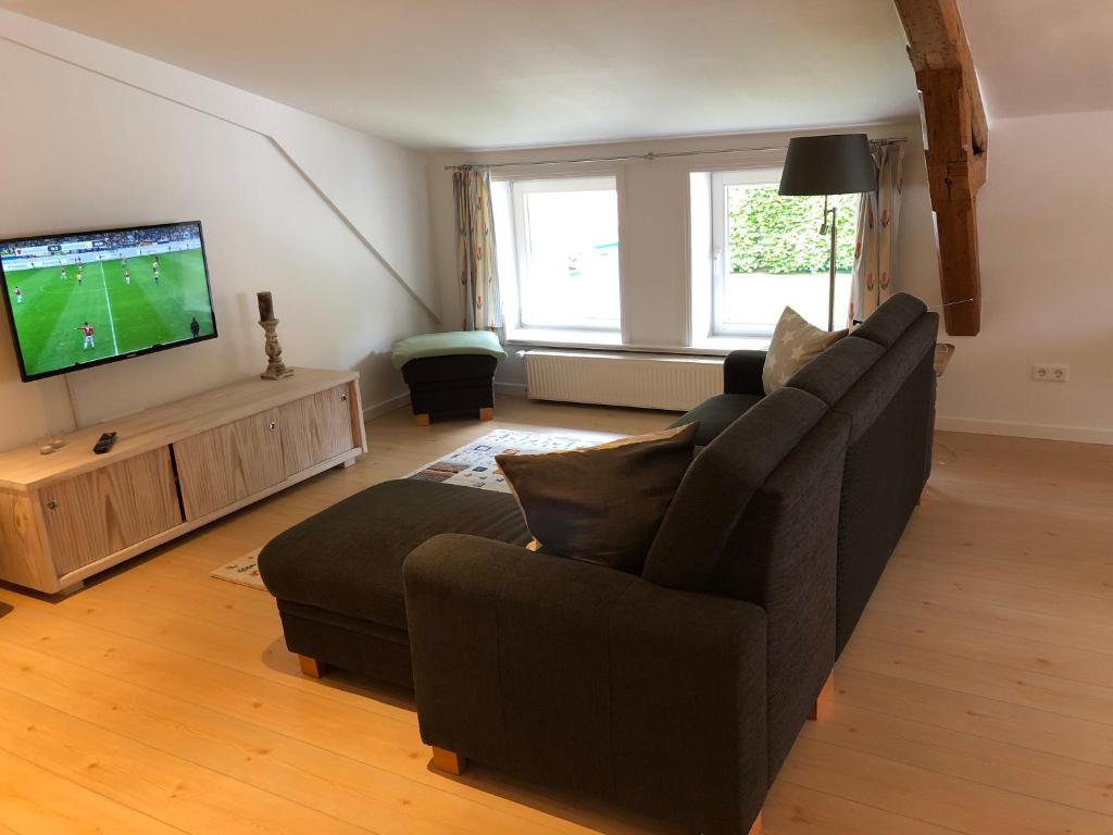 a living room with a couch and a television at Apartment 5 in Wyk auf Föhr