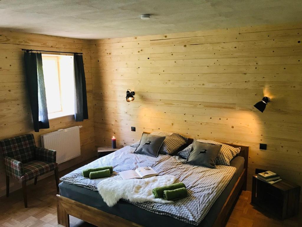 sypialnia z łóżkiem z drewnianą ścianą w obiekcie Altes Forstamt Altenau w mieście Altenau
