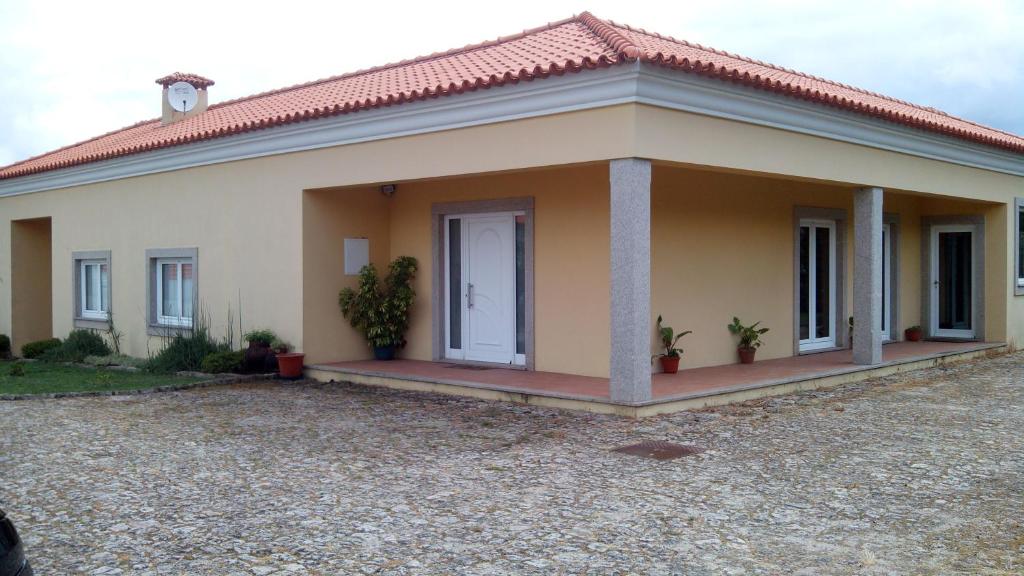 a small house with a driveway in front of it at Casa das Bocelinhas in Arouca