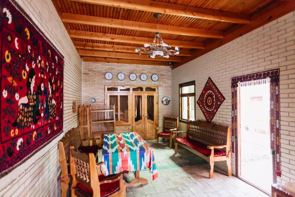 a room with a table and chairs and a couch at Trip.LE Hostel Samarkand in Samarkand