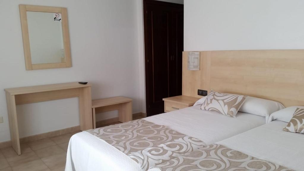 A bed or beds in a room at Hotel Rias Baixas