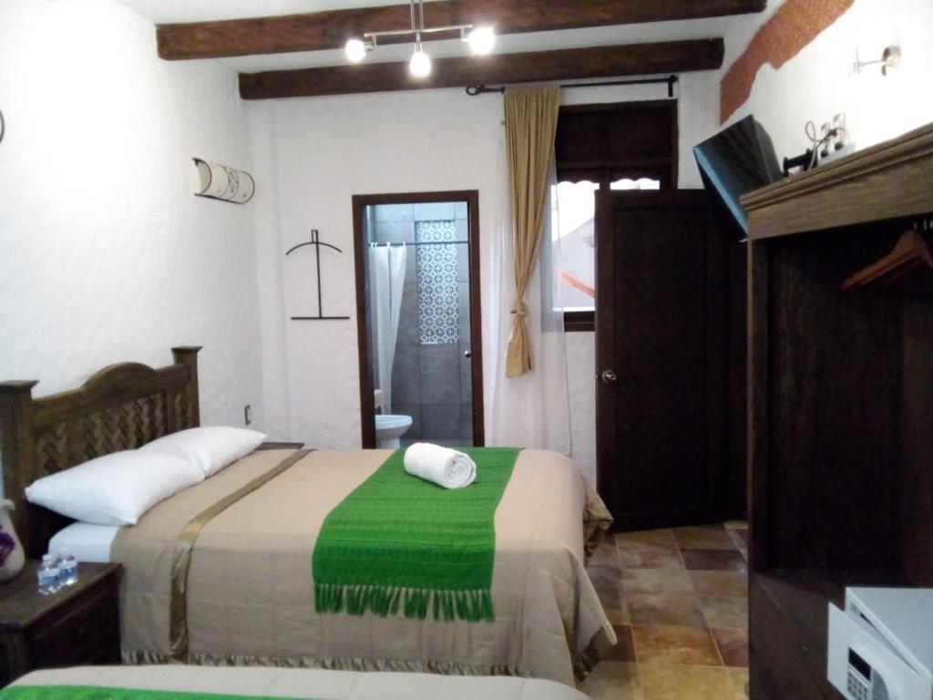 Ένα ή περισσότερα κρεβάτια σε δωμάτιο στο Hotel Na´Lum