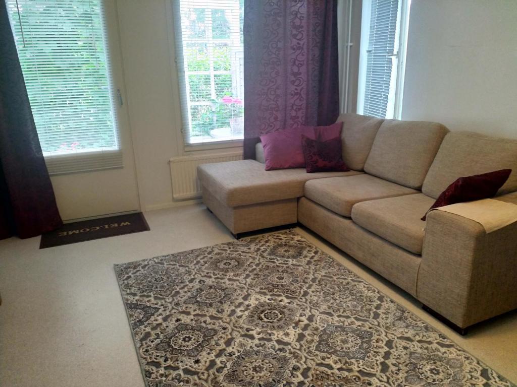 a living room with a couch and a rug at Apartment Mikkelissä, Silvasti in Mikkeli