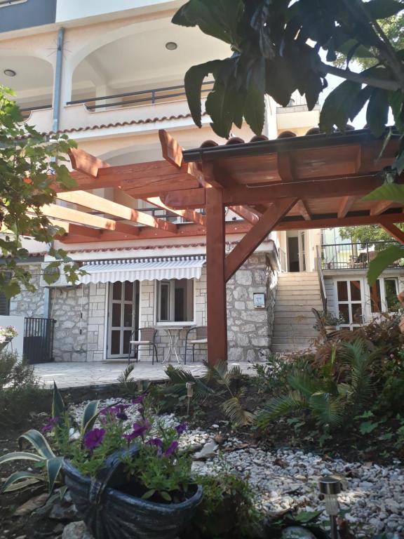 a wooden pergola in front of a house at App Ruzica in Crikvenica