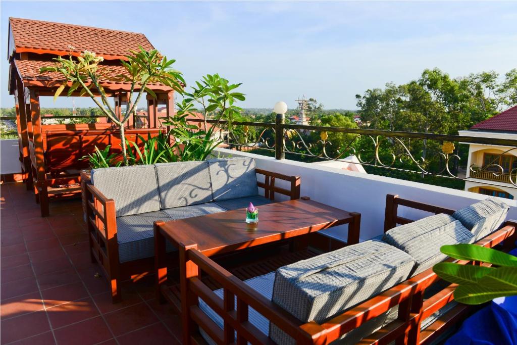 a patio with two chairs and a table on a balcony at Royal Crown Hotel & Spa in Siem Reap