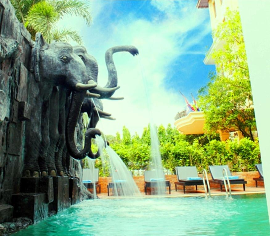 a fountain in the middle of a pool with an elephant statue at Royal Crown Hotel & Spa in Siem Reap