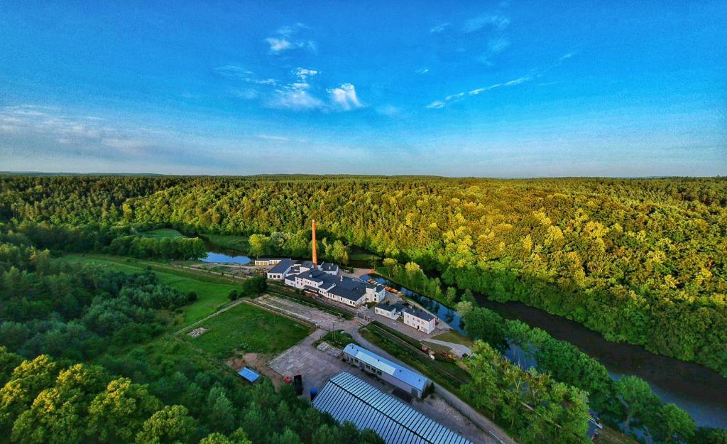 an aerial view of a building next to a river at Remiza w Starej Papierni in Łapino