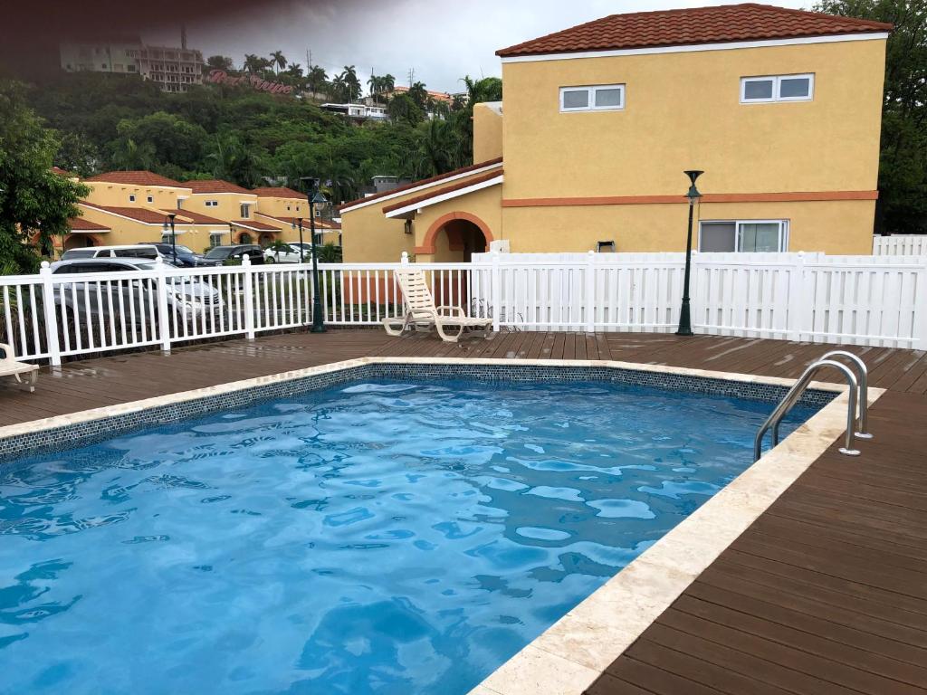 a large swimming pool in front of a house at Anna's Joye Chatham in Montego Bay