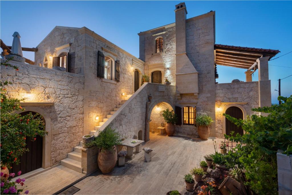 an exterior view of a stone house with a courtyard at Villa Pantelis in Elefterna