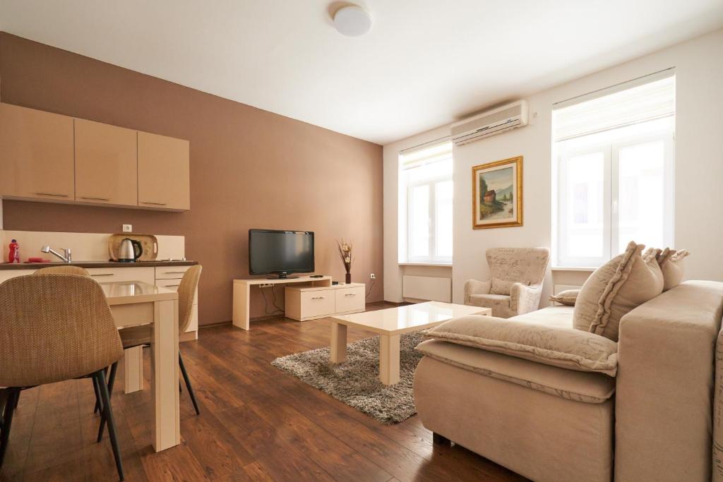 a living room with a couch and a table at Central Inn Apartments Sarajevo in Sarajevo