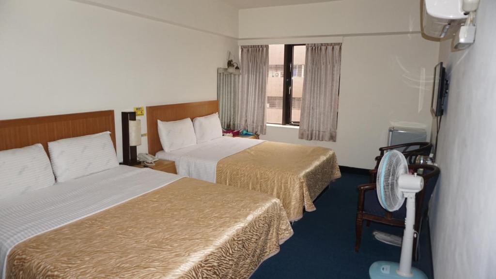 Postel nebo postele na pokoji v ubytování Chian Huei Business Hotel