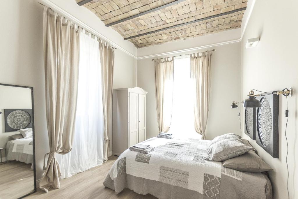a bedroom with a bed and a large window at Casa di Ele in Rome