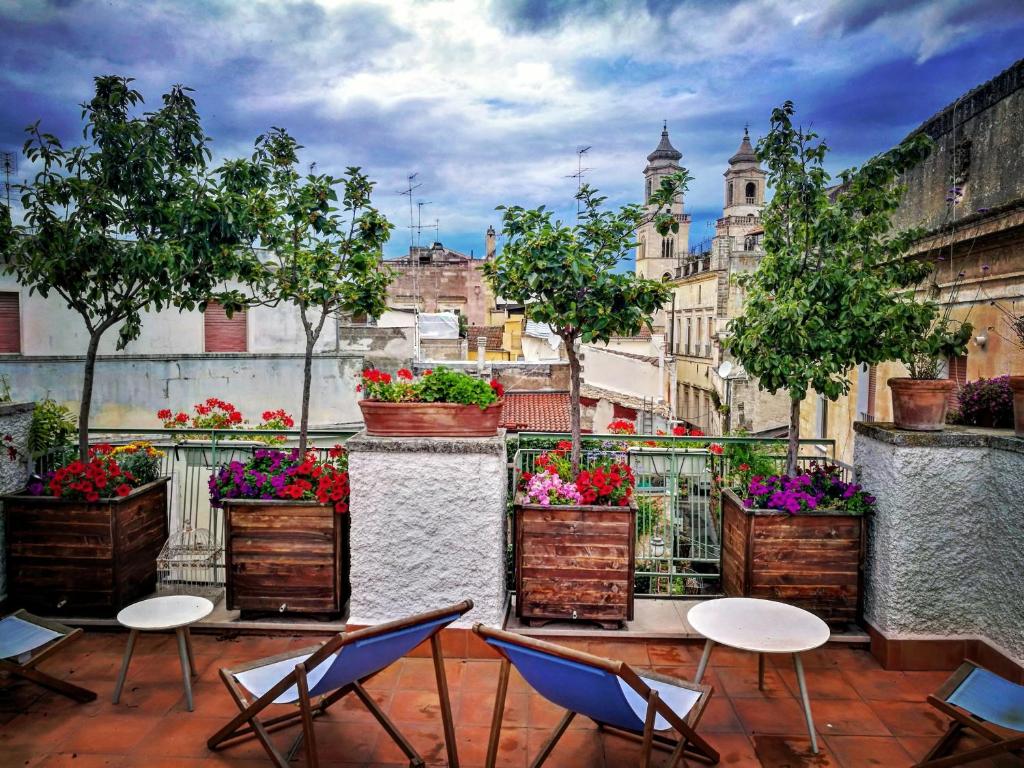 een balkon met stoelen en potplanten op een gebouw bij Casa Farella B&B in mini Apartments Altamura x Matera in Altamura