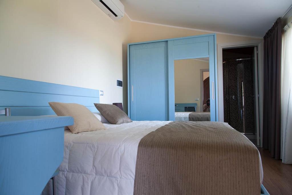 Postel nebo postele na pokoji v ubytování B&B Le Rose del Tirreno