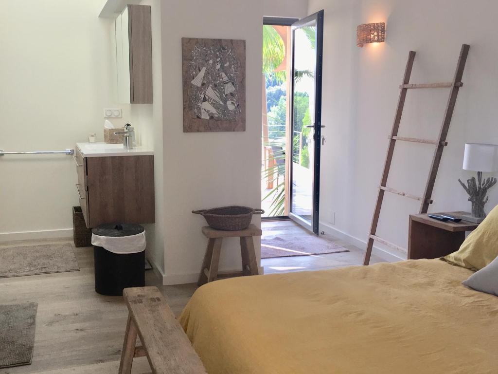 a bedroom with a bed and a sink and a bathroom at villa Sant-Anna in Saint-Tropez