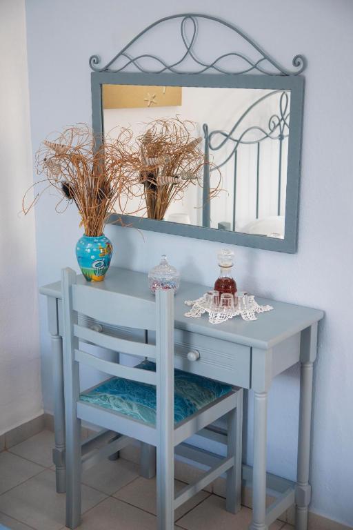 a blue dressing table with a mirror on it at Pension Barbara in Katapola