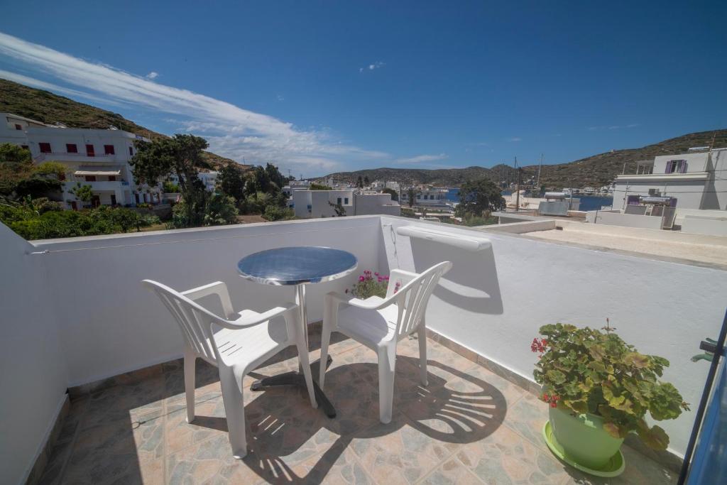 a balcony with a table and chairs on a roof at Pension Barbara in Katapola