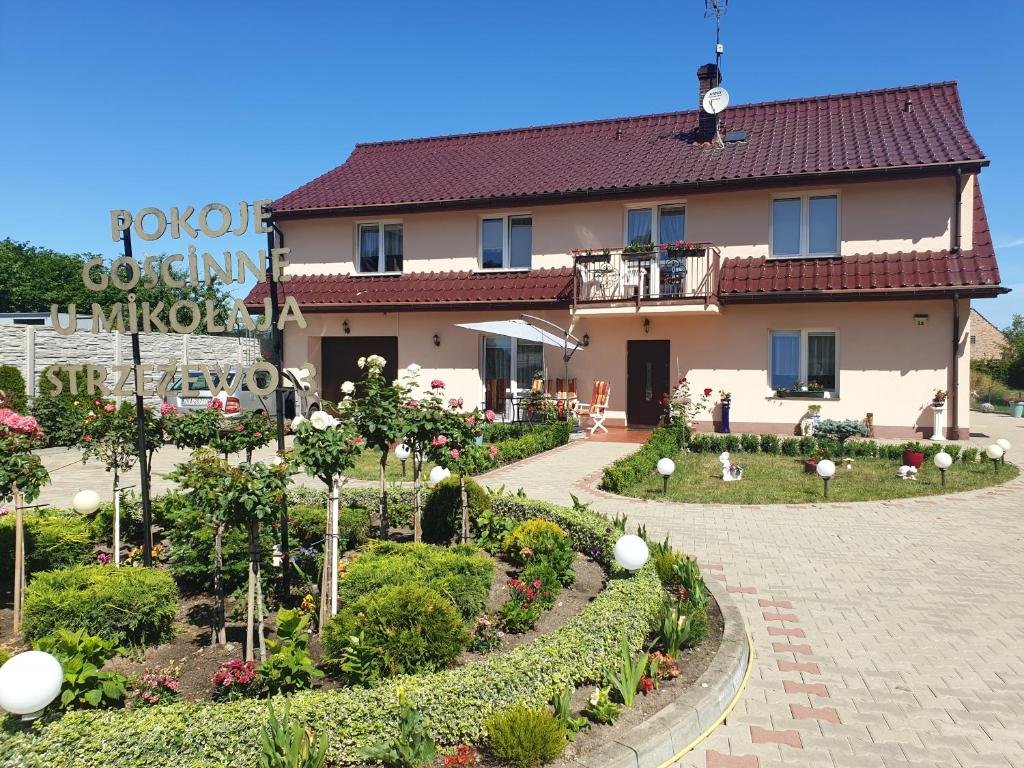 a large house with a garden in front of it at POKOJE U MIKOŁAJA in Kamień Pomorski