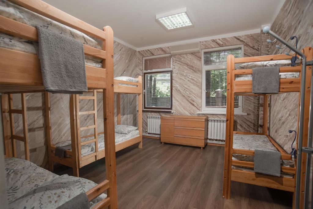a room with four bunk beds and a desk at Hostel Manjari in Sochi
