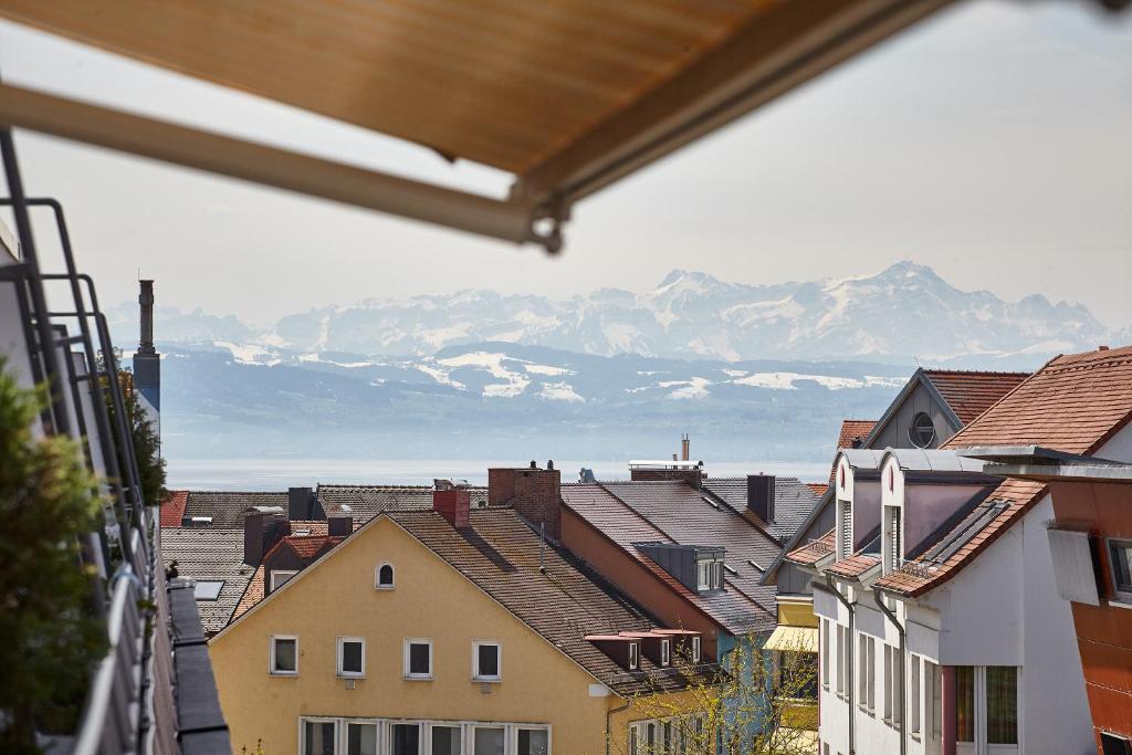a view of a city with mountains in the background at Casa Pinos City in Friedrichshafen