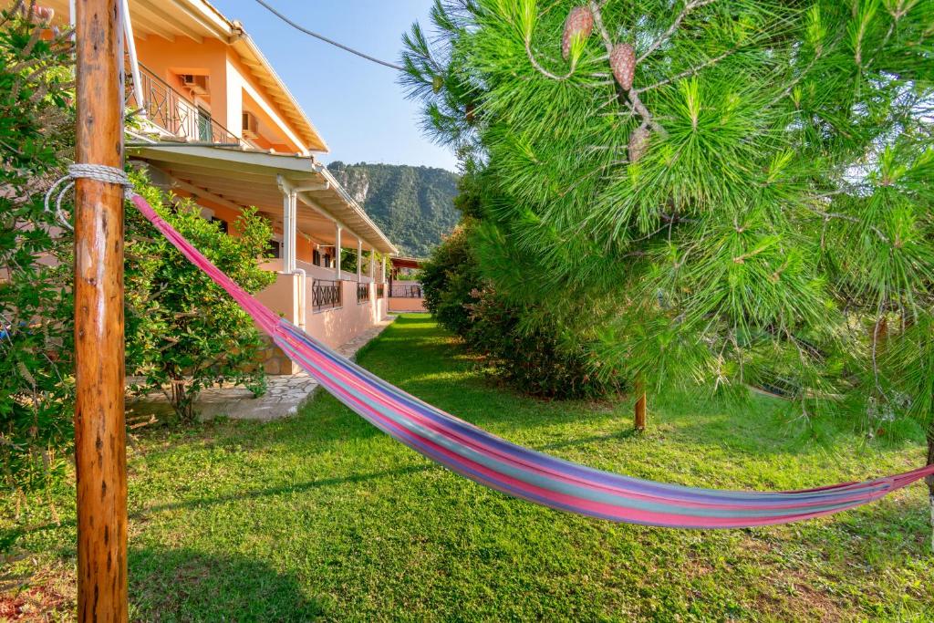 a hammock in a yard next to a house at Evaggelia Studios in Lefkada Town