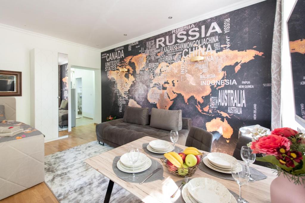a living room with a table and a wall with a map at Inter Apartment Vienna-Nähe Schönbrunn Palace in Vienna