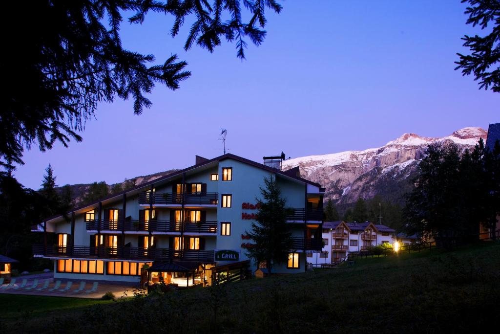 a hotel in the mountains at night at Hotel Alaska in Folgarida