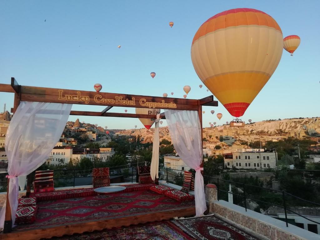 a hot air balloon flying over a balcony at Lucky Cave Hotel Cappadocia in Goreme