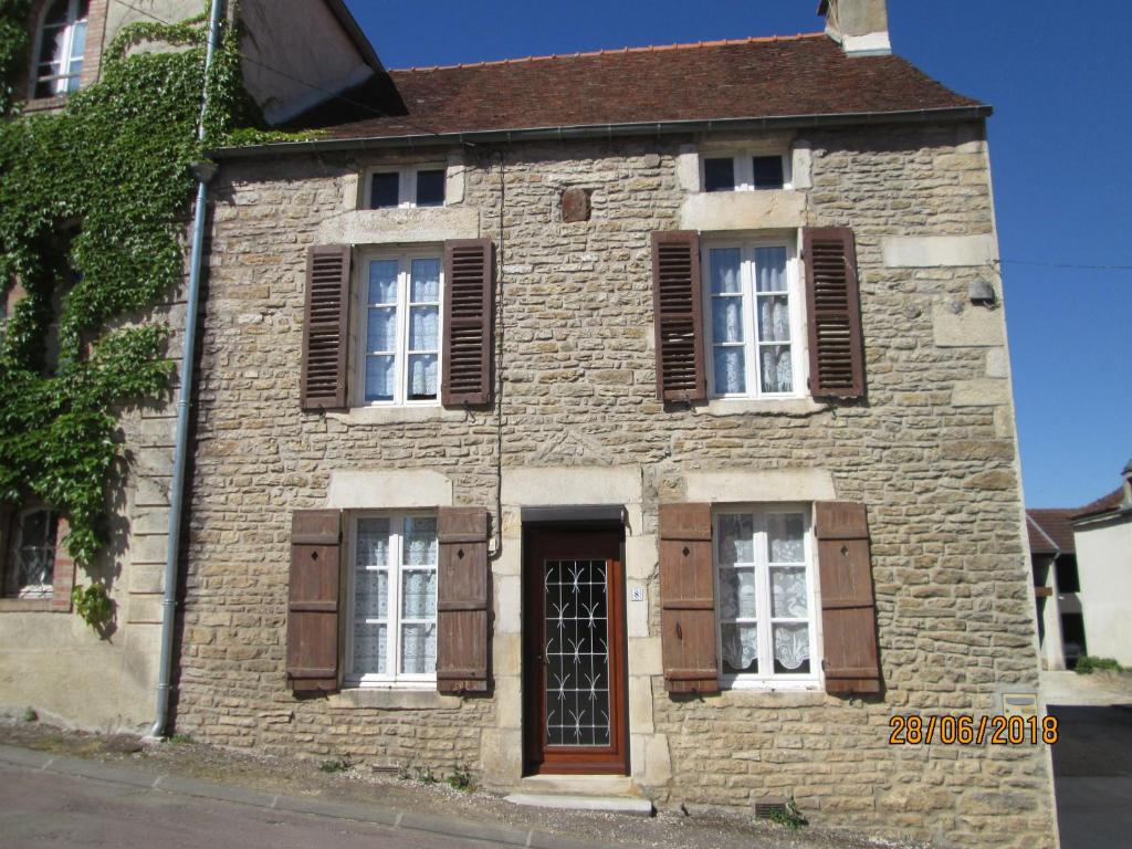an old stone house with brown shuttered windows at GITE A SAINT-REMY (21500) in Saint-Rémy