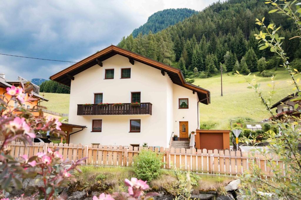 a house in the mountains with a fence at Ferienwohnung Eller 79 in Vals