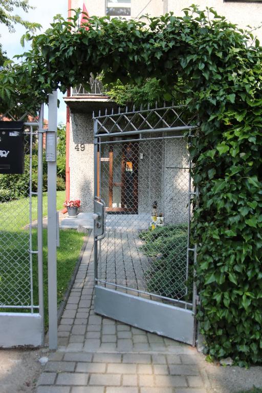 an entrance to a garden with a gate at Apartament u Adeli in Gdynia