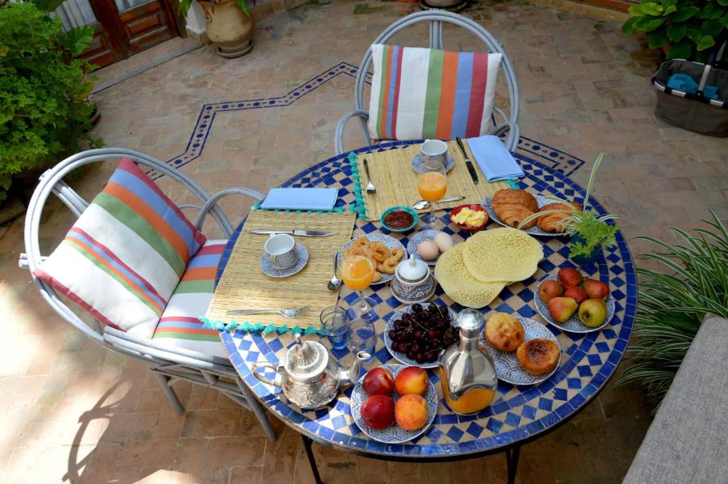 a blue table with breakfast foods on it at RIAD OASIS D'ASILAH in Asilah