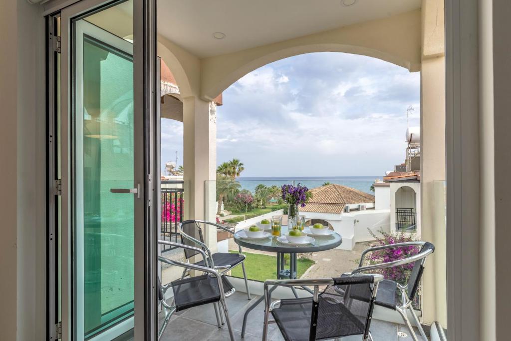a balcony with a table and chairs and a view of the ocean at Sea View apartment in Pyla