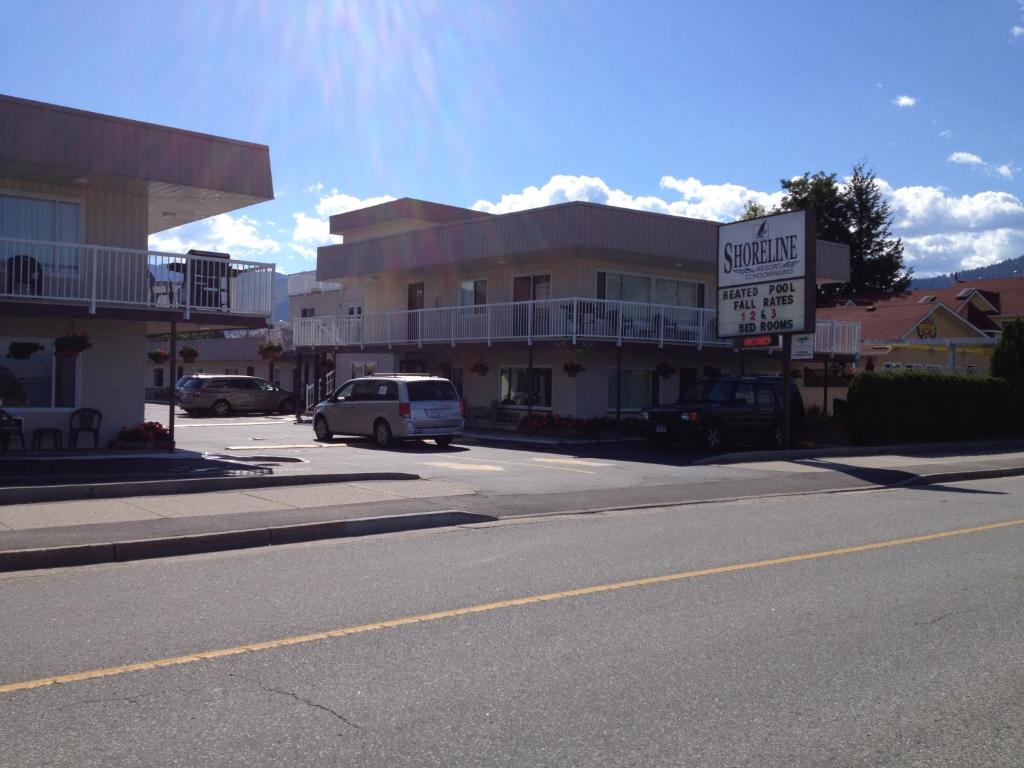 a street with a building and a car parked in front at Shoreline Resort Condominiums in Penticton