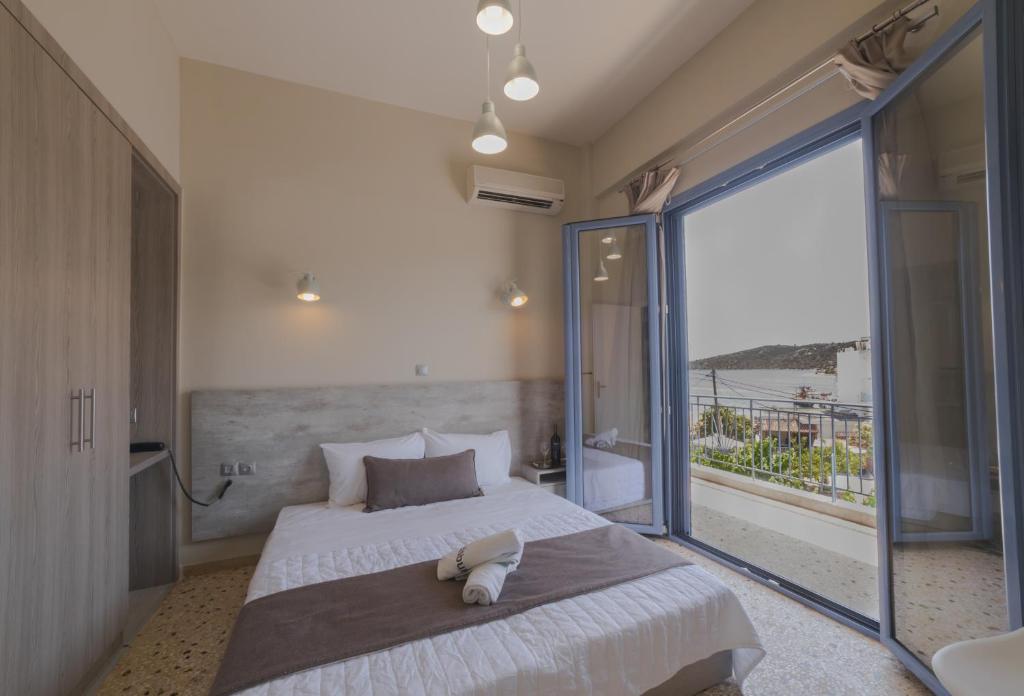 a bedroom with a large bed and a large window at Vivari Acta in Vivari